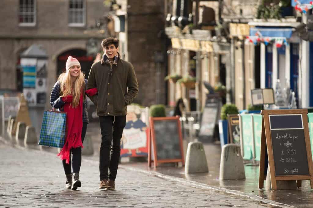 A young couple shop in the Grassmarket in Edinburgh, Scotland
