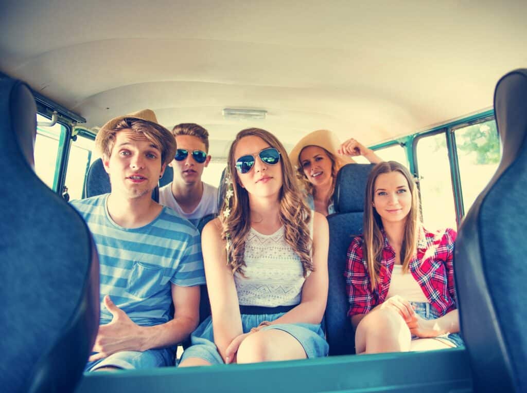 Group of young adults enjoying private executive travel in a luxury minibus in Edinburgh.